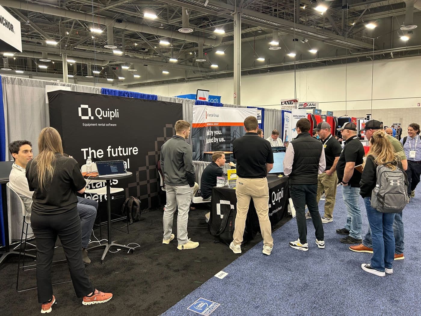 Rental operators talking with the Quipli team at the Quipli trade show booth