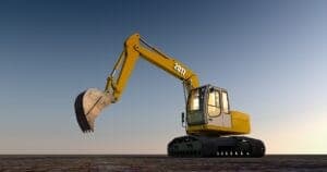 An excavator with a yellow arm and cab is stationary on barren ground beneath a clear sky. The arm is raised, and "2007" is visible on the arm.